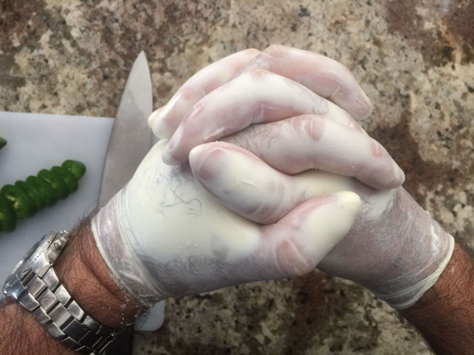 Rubbing hands while wearing gloves filled with Yohurt